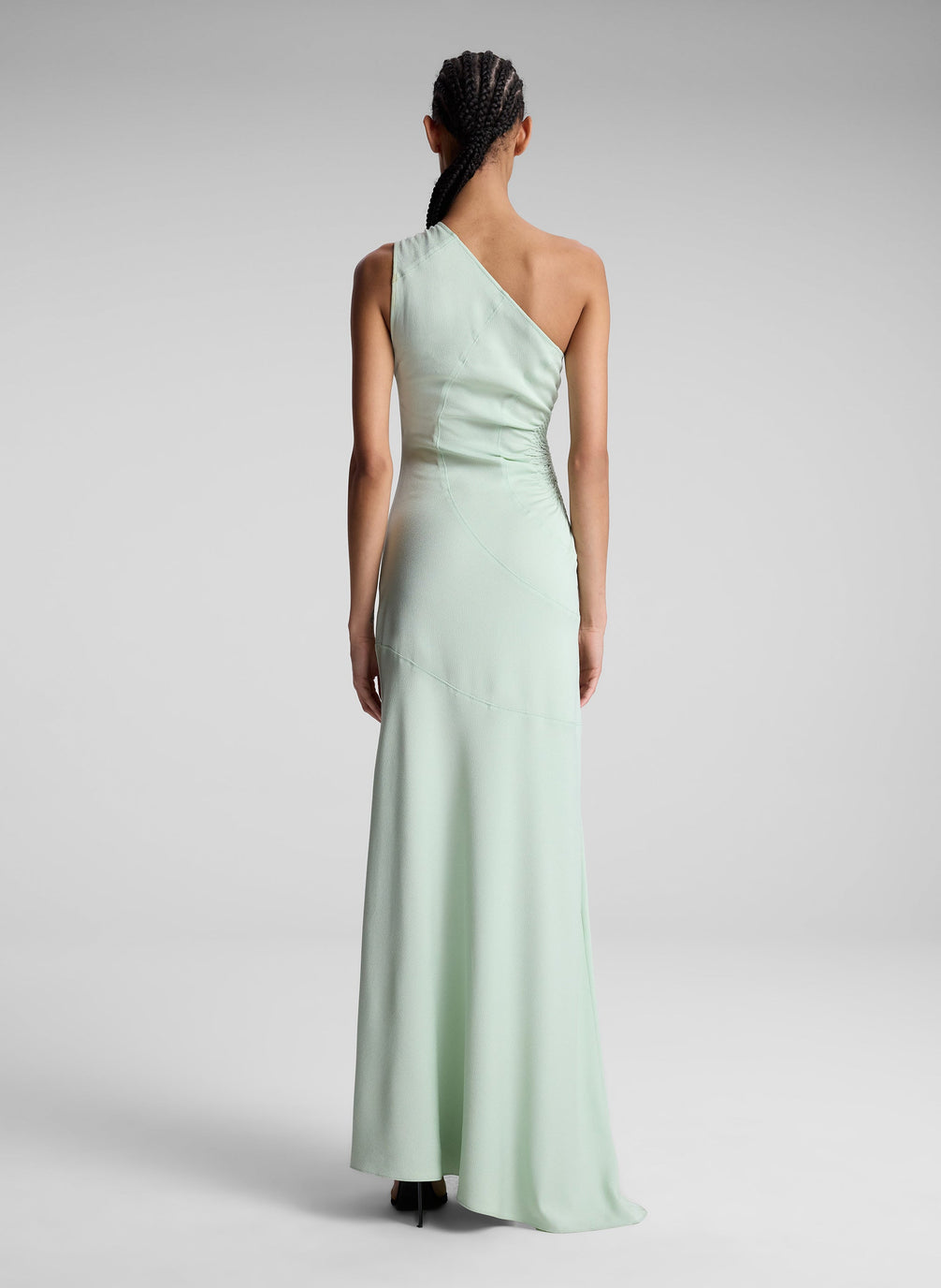 woman wearing light green one shoulder dress