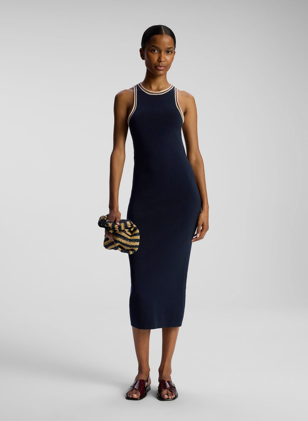 front view of woman wearing navy blue sleeveless knit midi dress