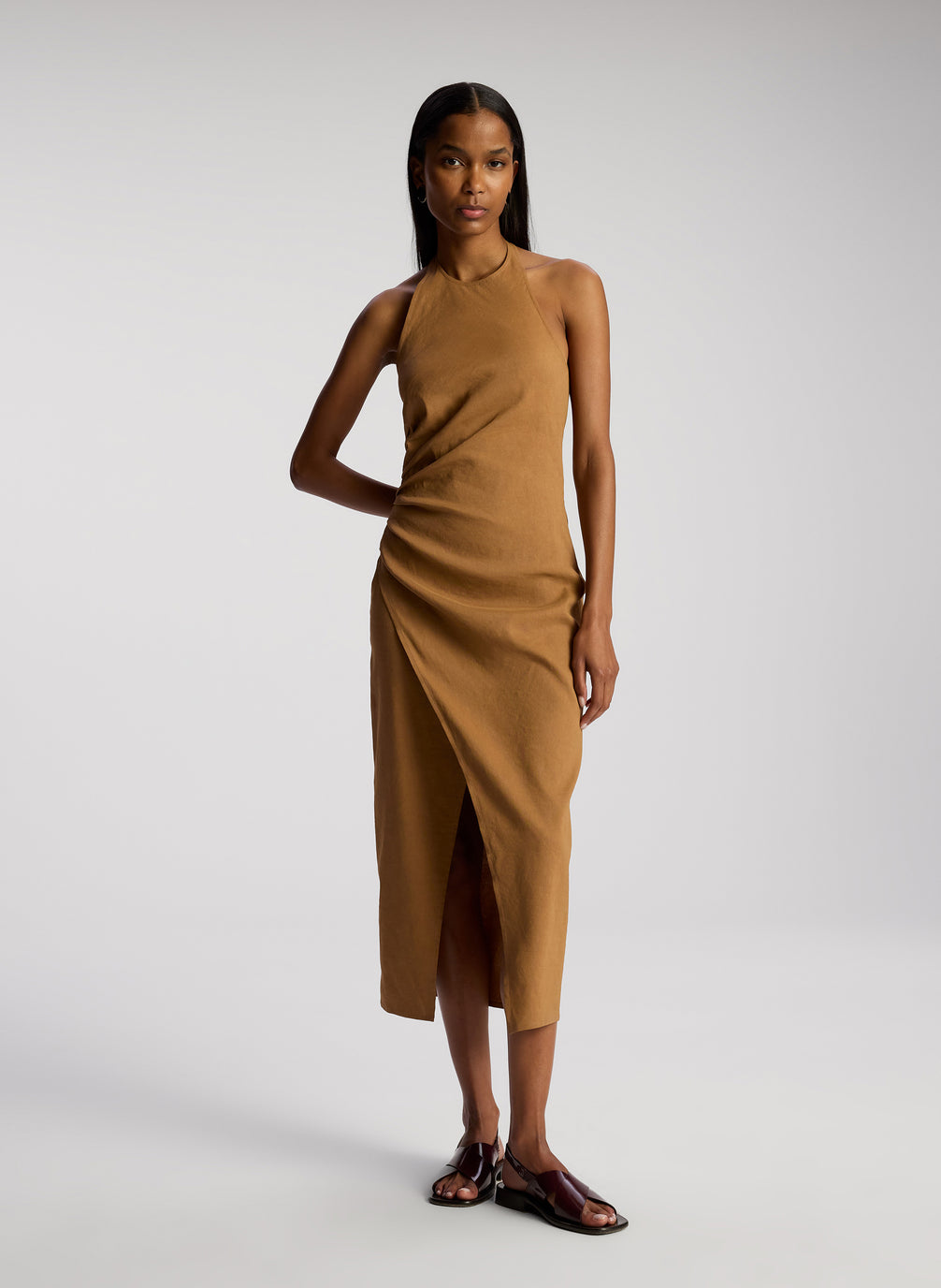 front view of woman wearing brown sleeveless midi dress
