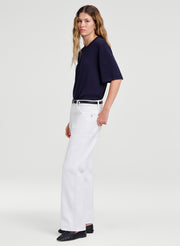 woman wearing blue top and white jeans