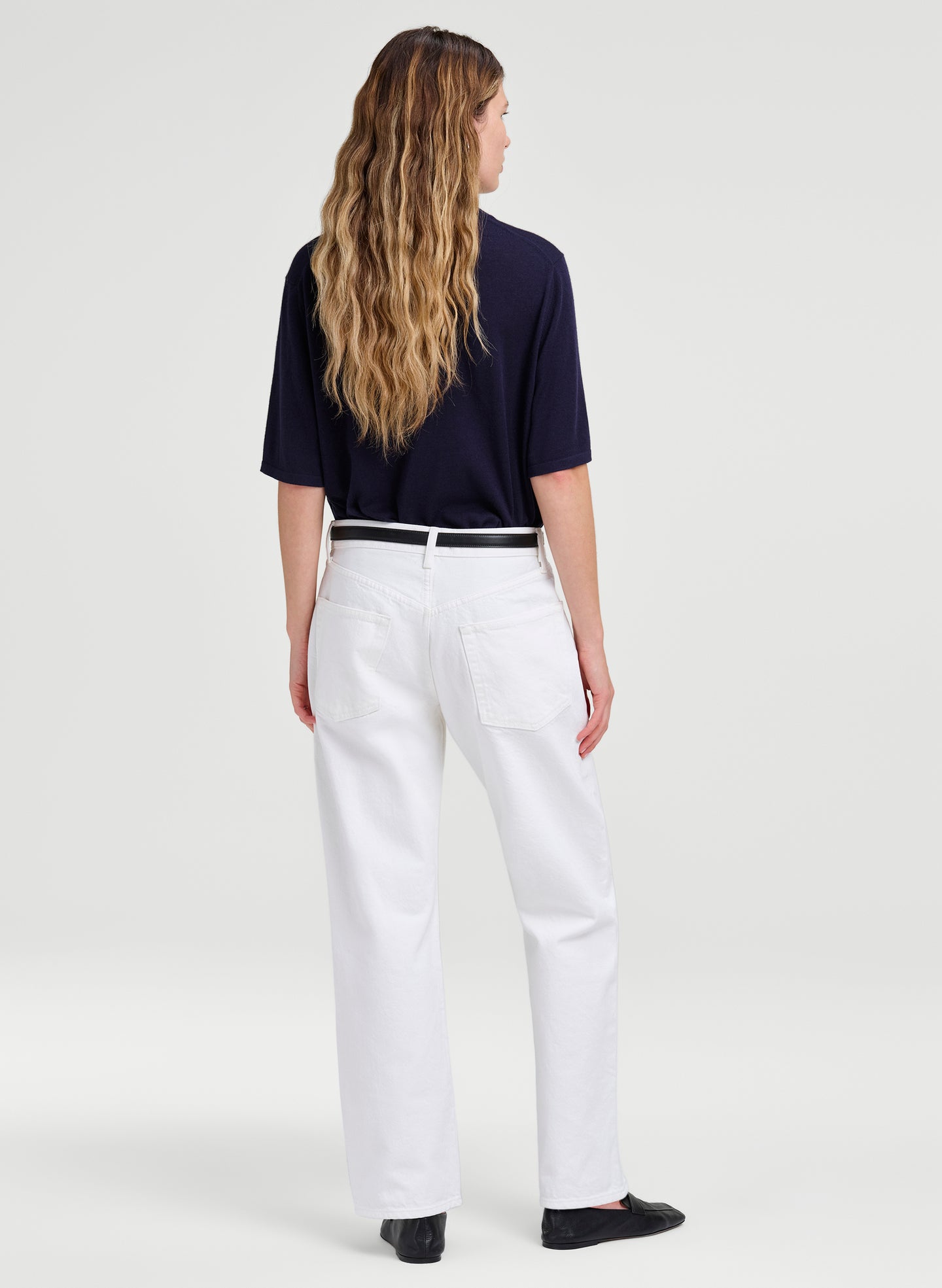 woman wearing white denim jeans and blue tee shirt