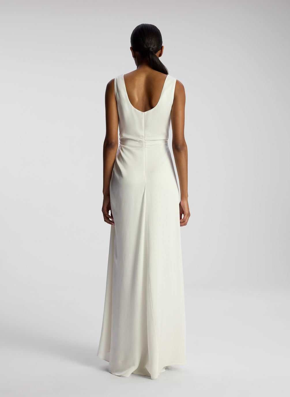 back view of woman wearing white maxi dress