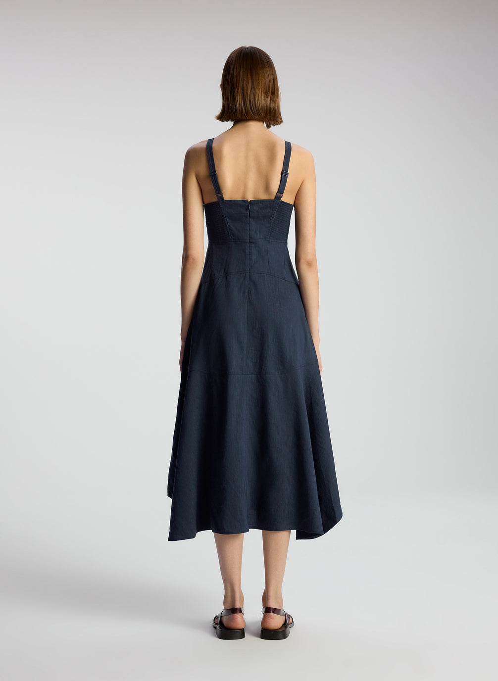back view of woman wearing navy blue sleeveless midi dress