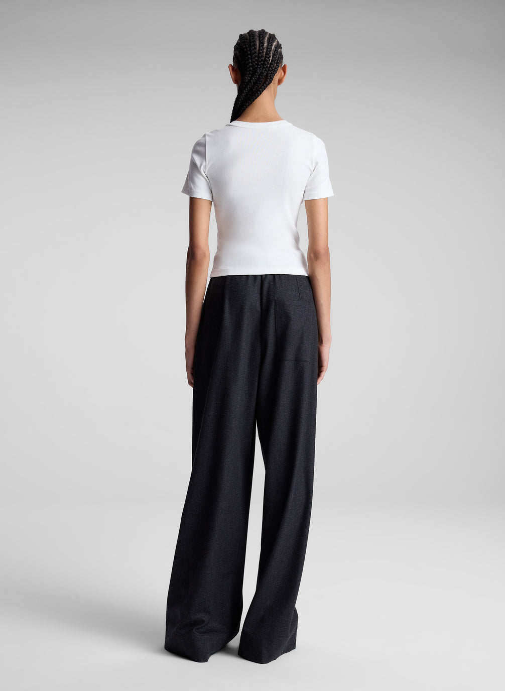 woman wearing white tee shirt and black pants