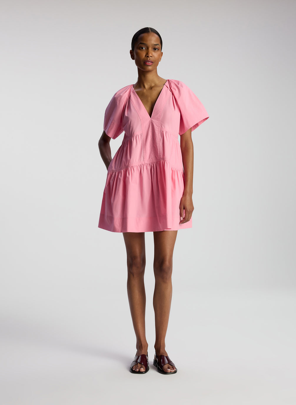 front view of woman wearing pink short sleeve minidress