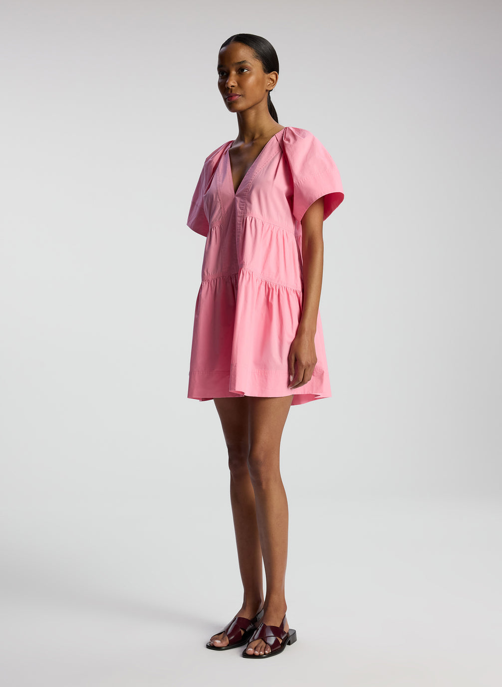 side view of woman wearing pink short sleeve minidress