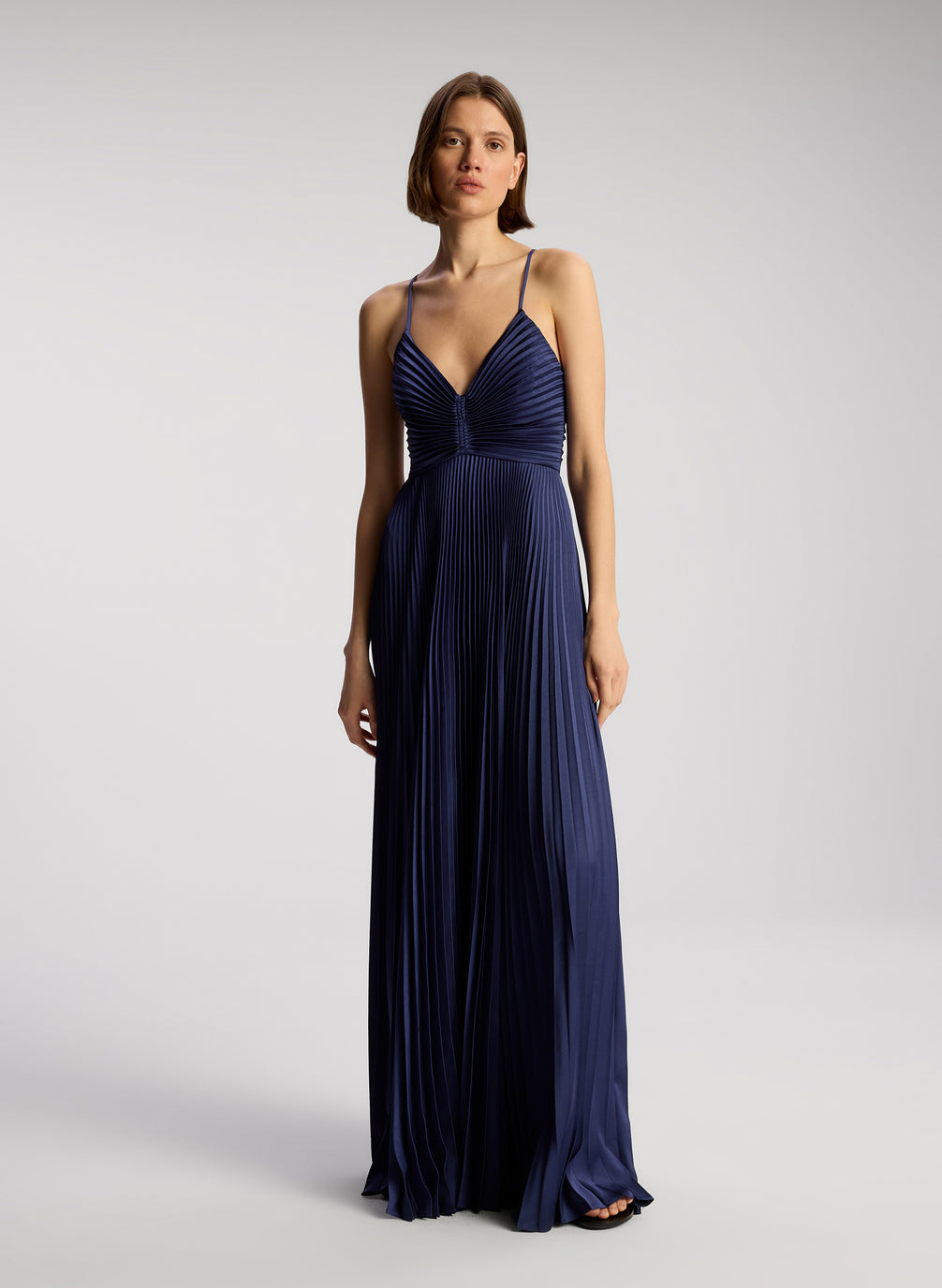 front view of woman wearing navy blue pleated maxi dress