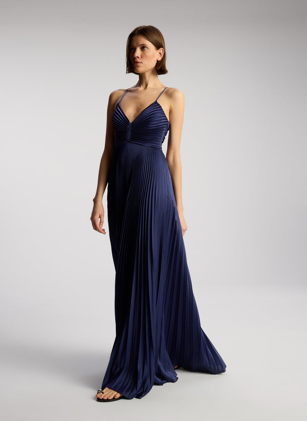side view of woman wearing navy blue pleated maxi dress