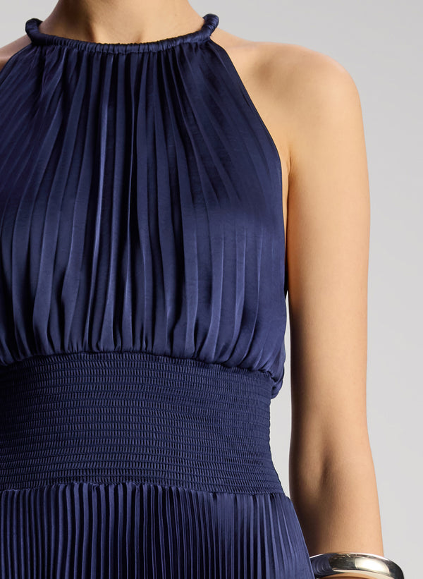 detail view of woman wearing navy blue sleeveless pleated midi dress