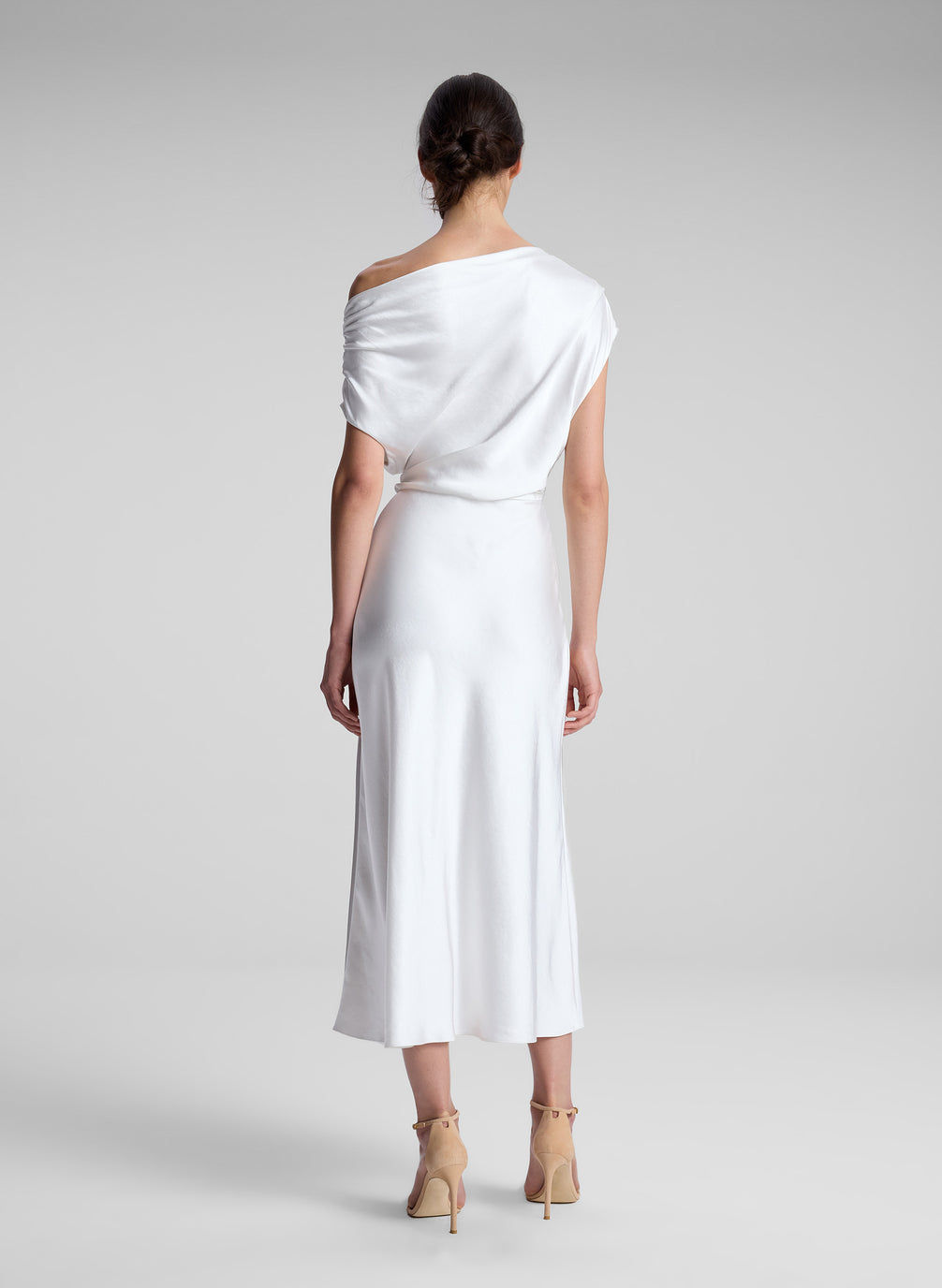 woman wearing white satin midi dress