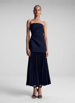 woman wearing navy blue strapless maxi dress