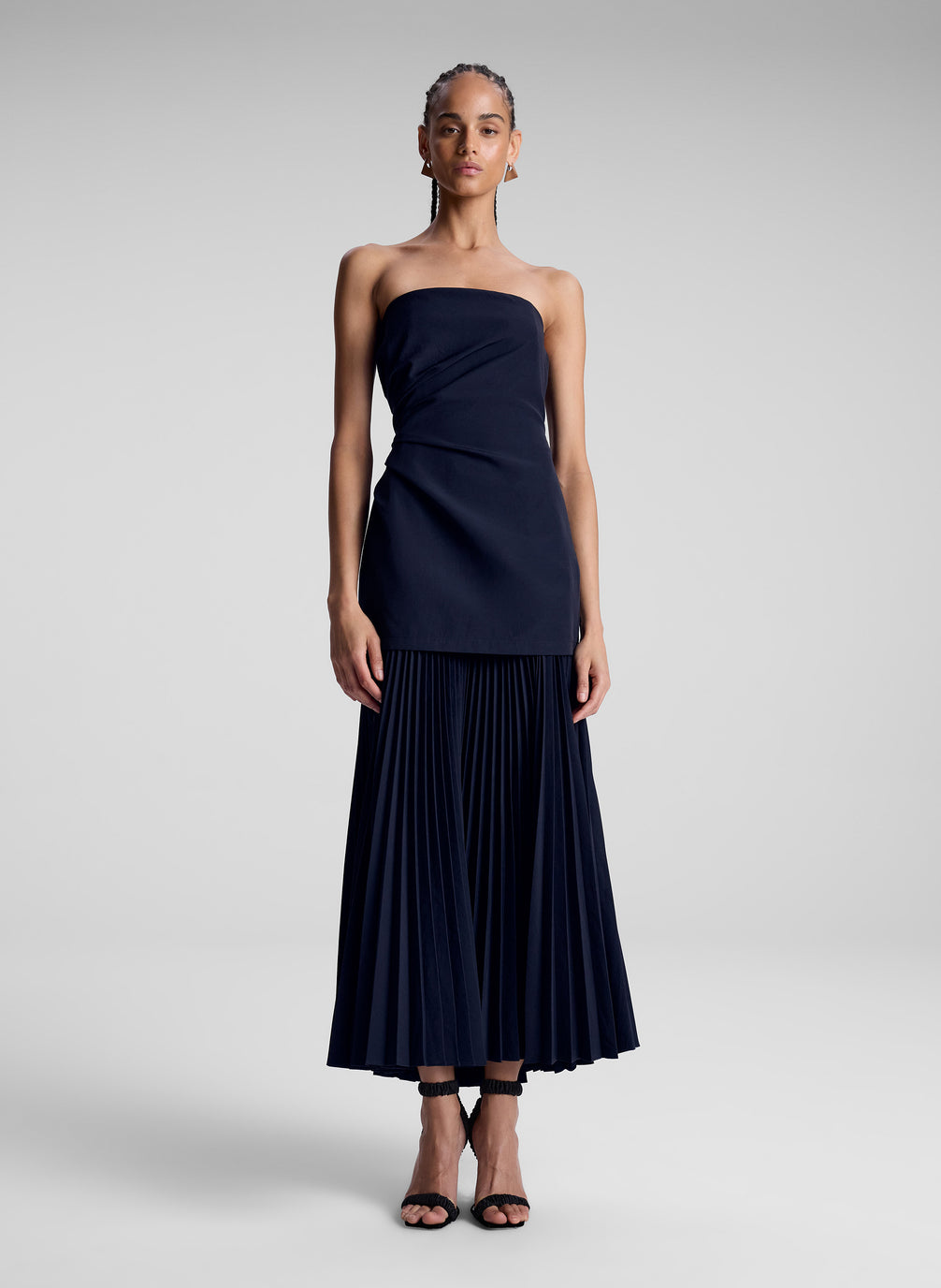 woman wearing navy blue strapless maxi dress