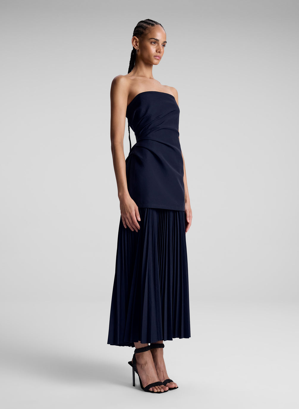 woman wearing navy blue strapless maxi dress