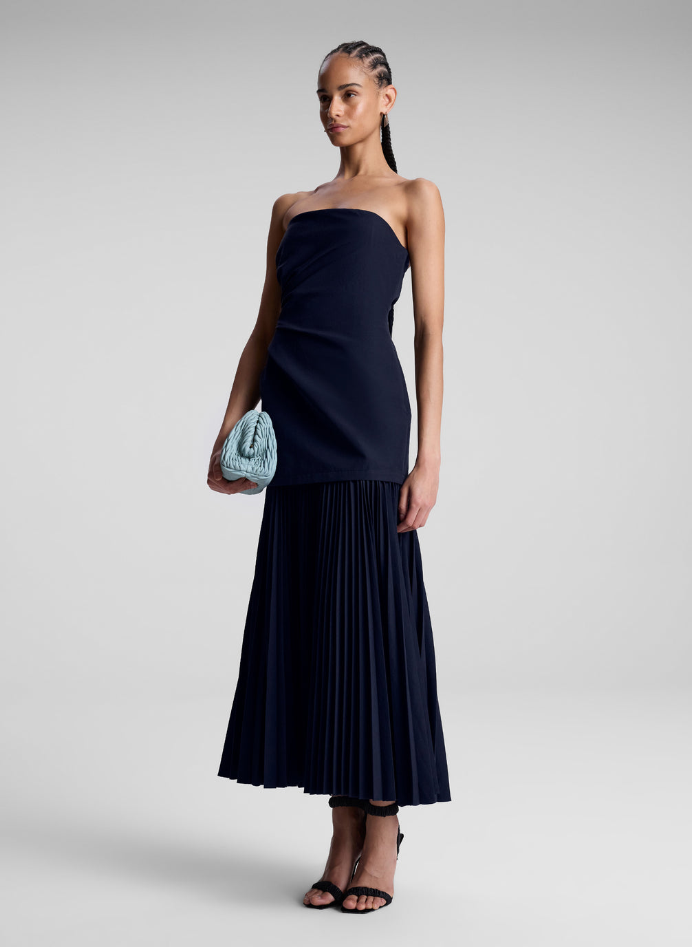 woman wearing navy blue strapless maxi dress