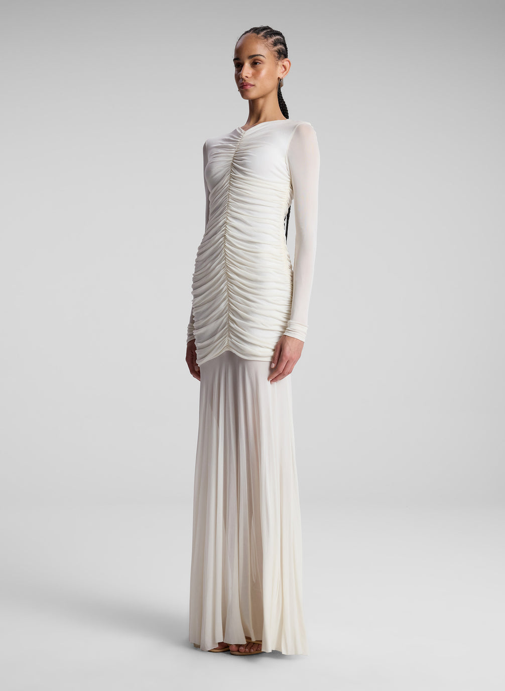 woman wearing white ruched long sleeve maxi dress