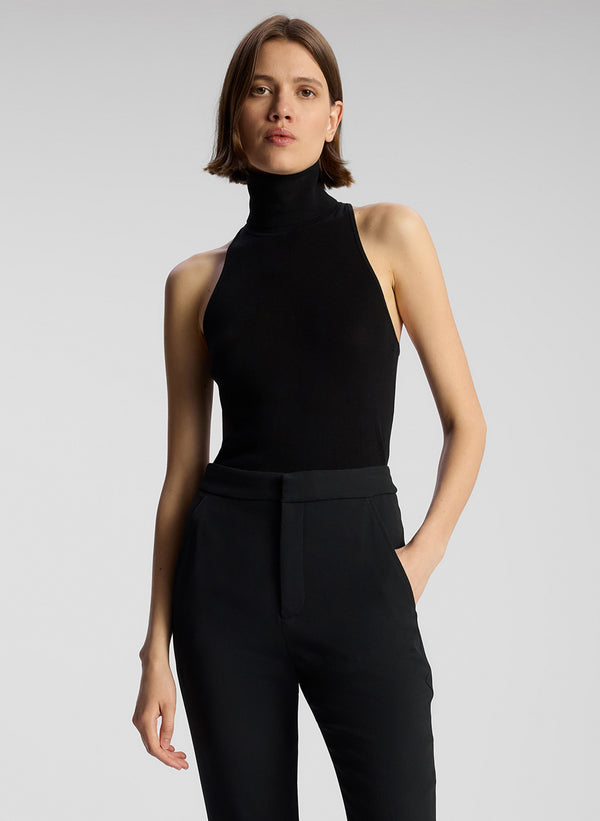 front view of woman wearing black sleeveless turtleneck and black pants