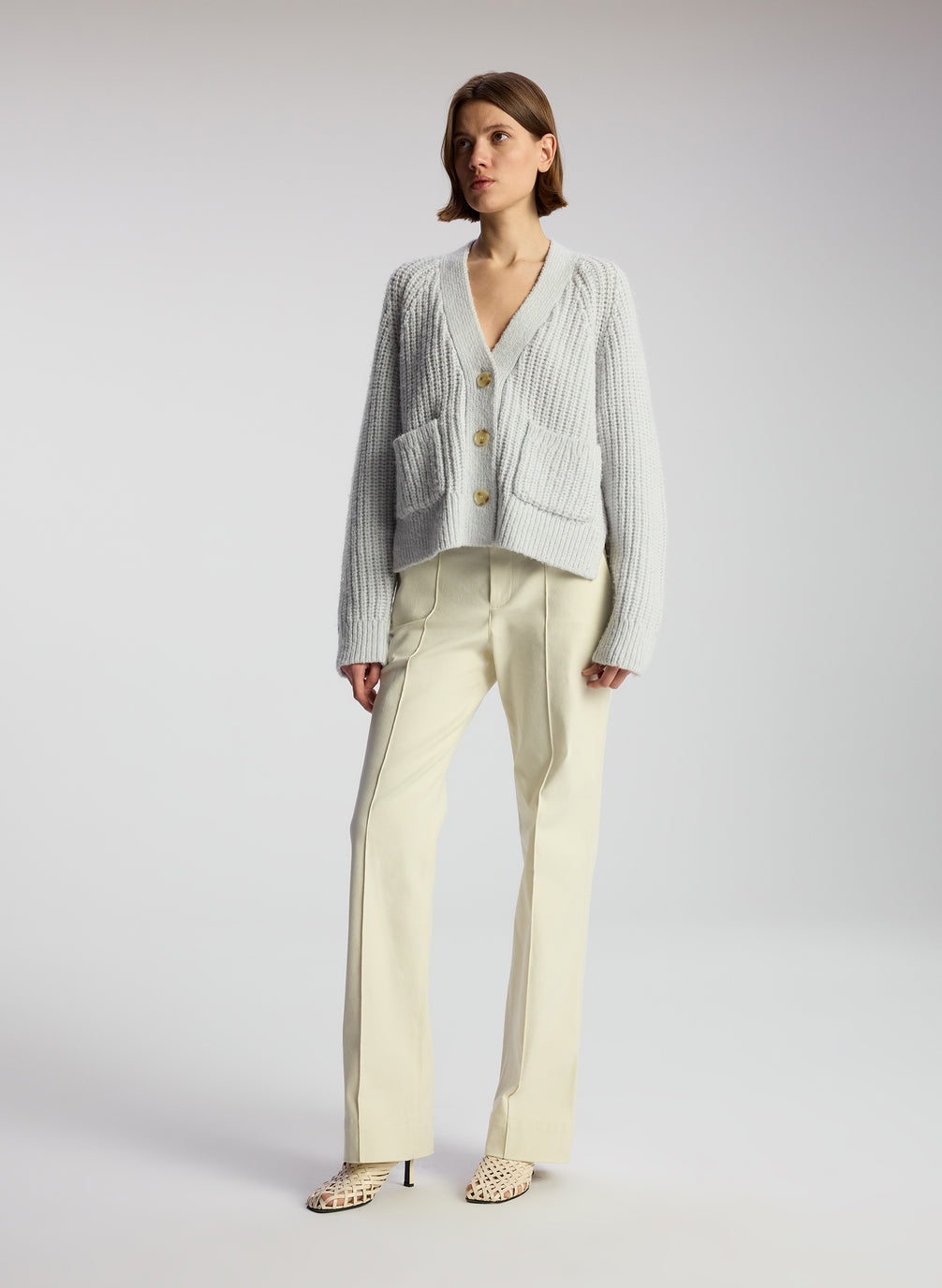 woman wearing beige pants and blue cardigan