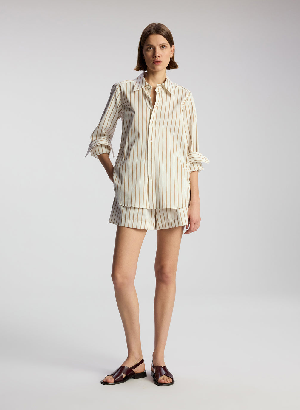 front view of woman wearing striped long sleeve shirt and matching shorts