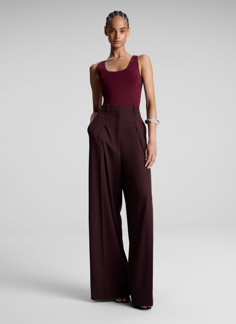 woman wearing burgundy tank top and brown pants