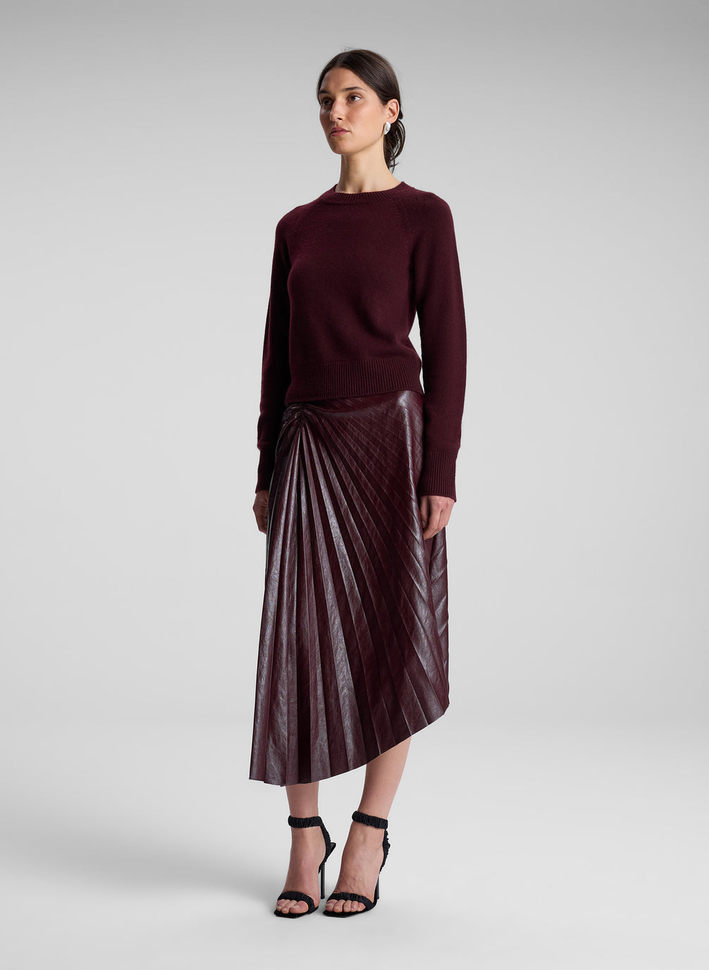 woman wearing burgundy sweater and maroon skirt