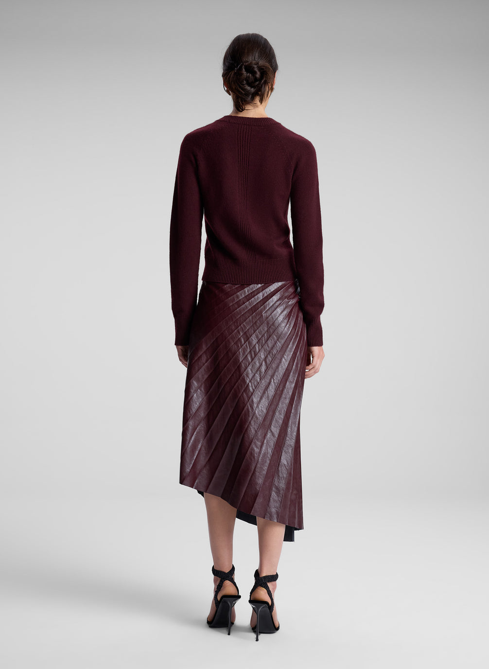 woman wearing burgundy sweater and maroon skirt