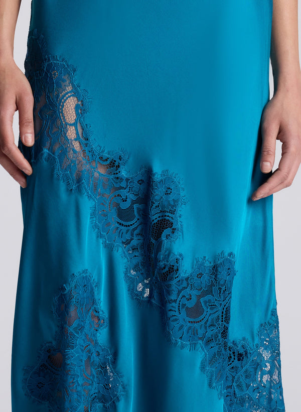 woman wearing teal lace maxi dress