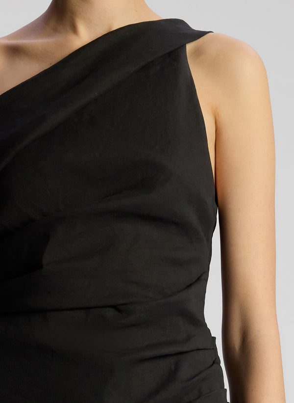 detail view of woman wearing black one shoulder mini dress