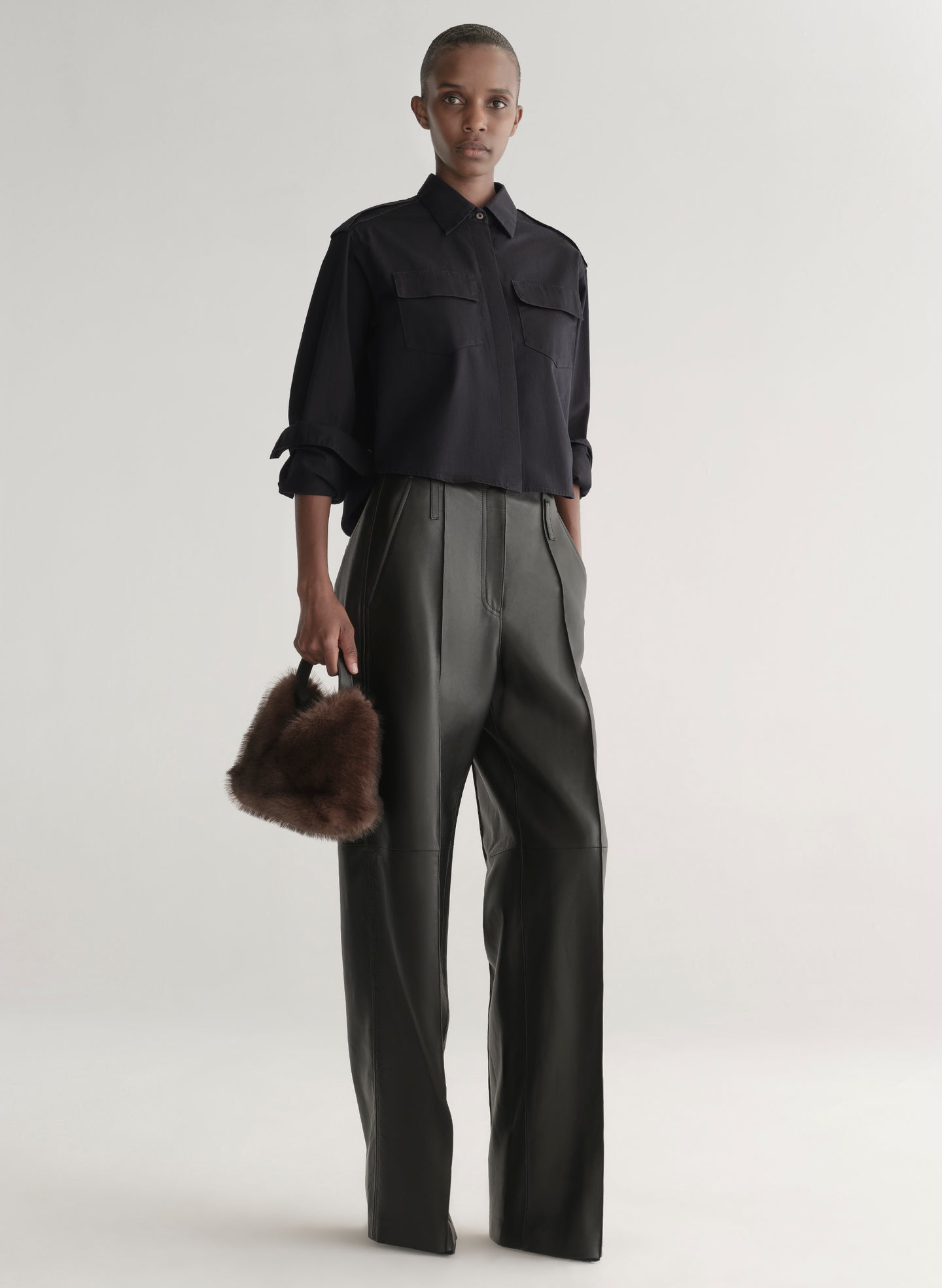 woman holding faux fur bag