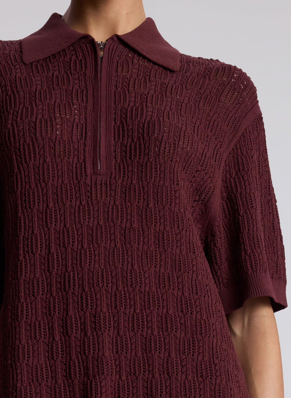 woman wearing burgundy knit polo and matching pants