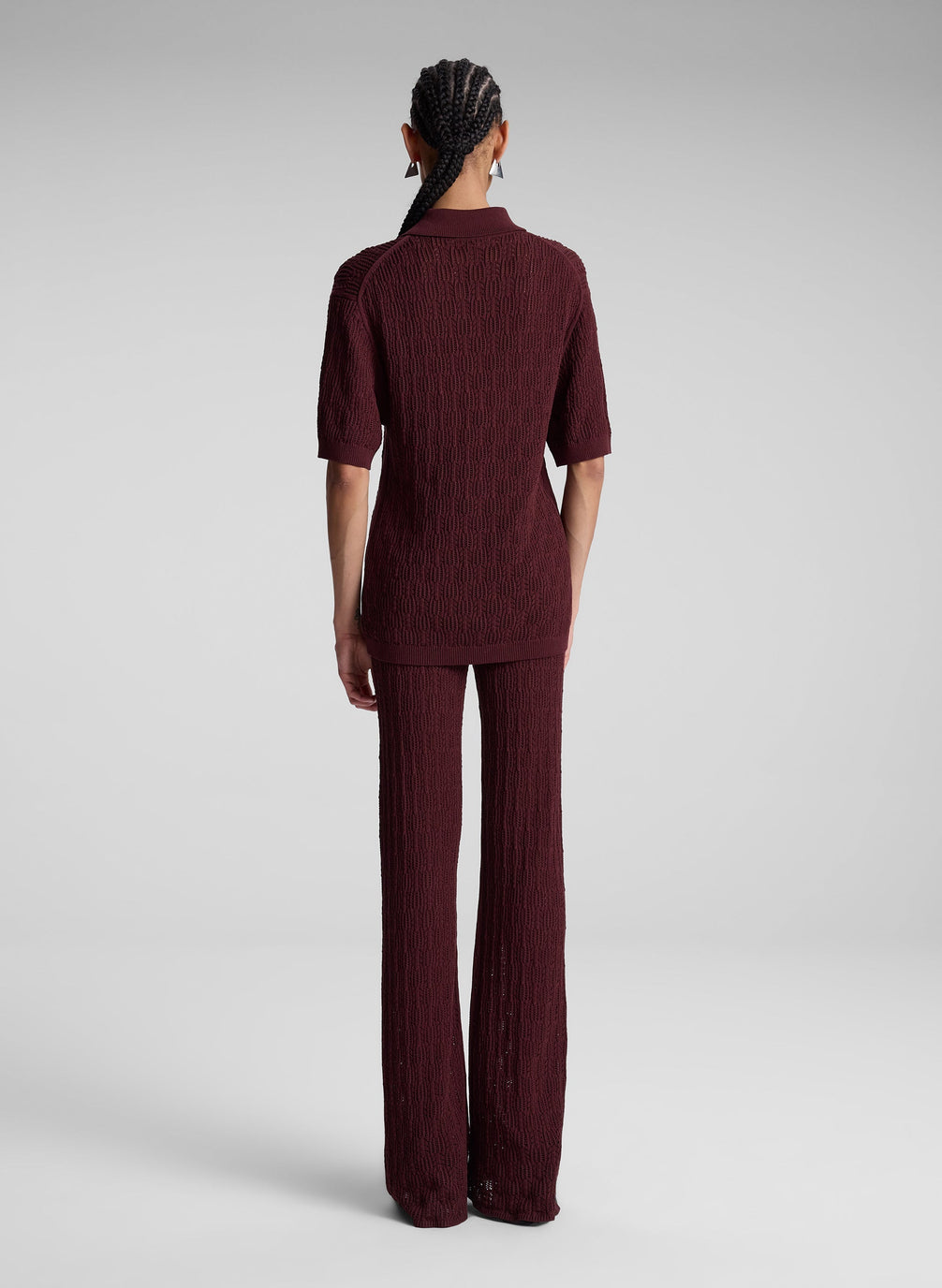 woman wearing burgundy knit polo and matching pants