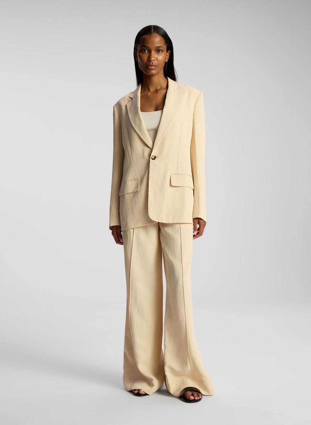 front view of woman wearing cream blazer and matching wide leg pants