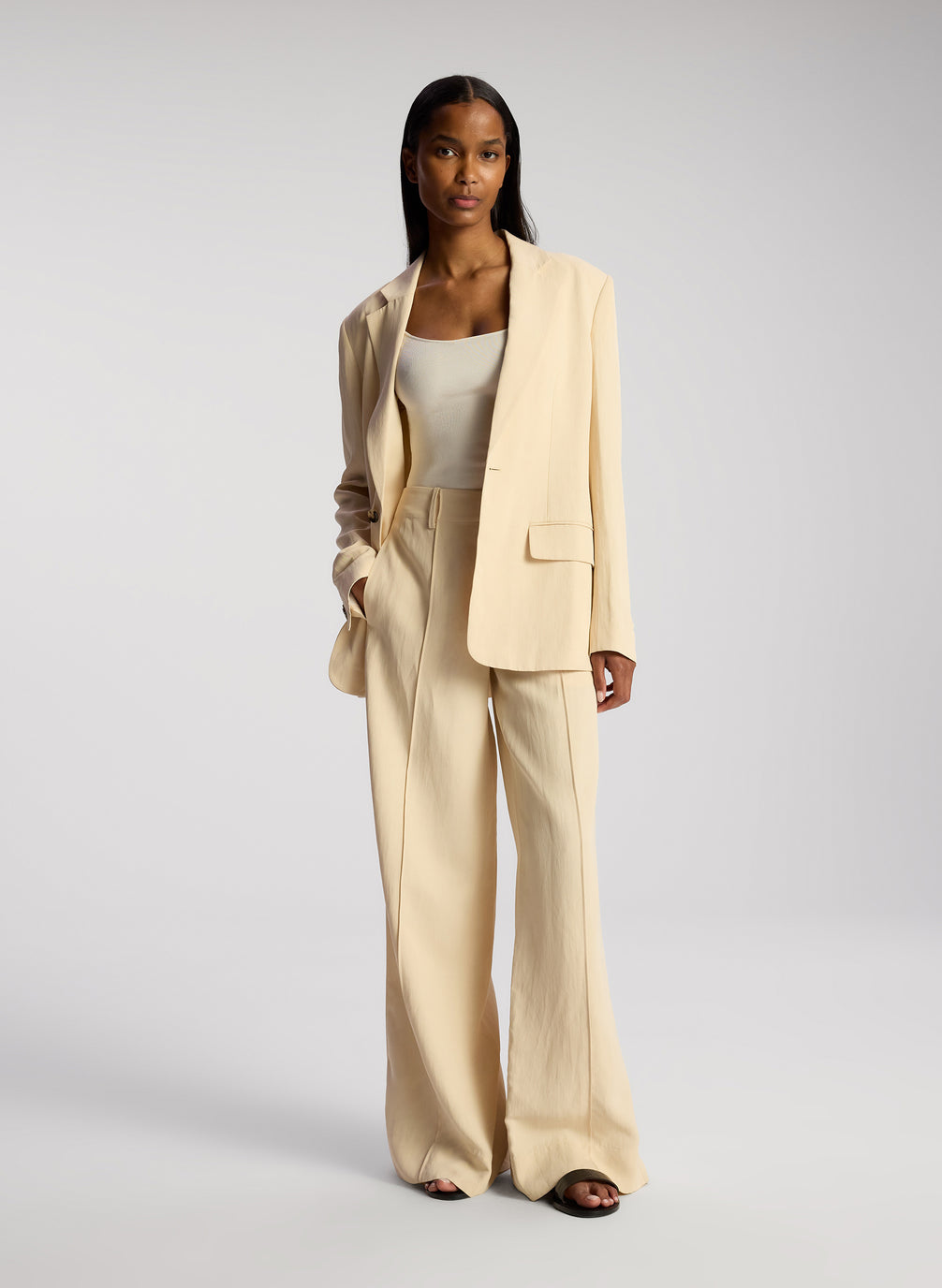 front view of woman wearing cream blazer and matching wide leg pants