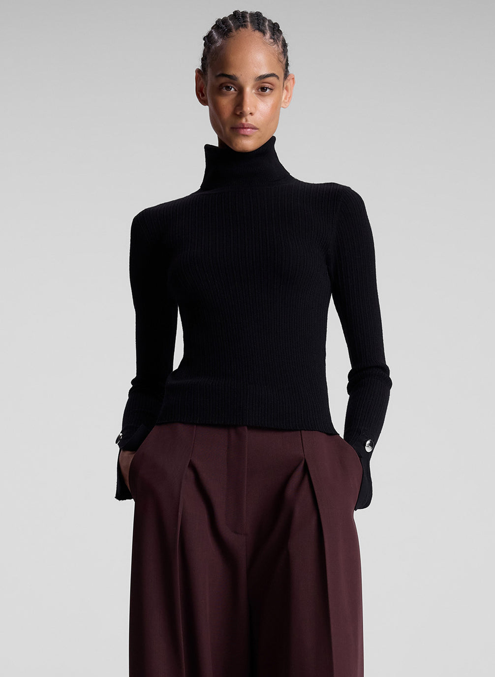 woman wearing black turtleneck and maroon pants