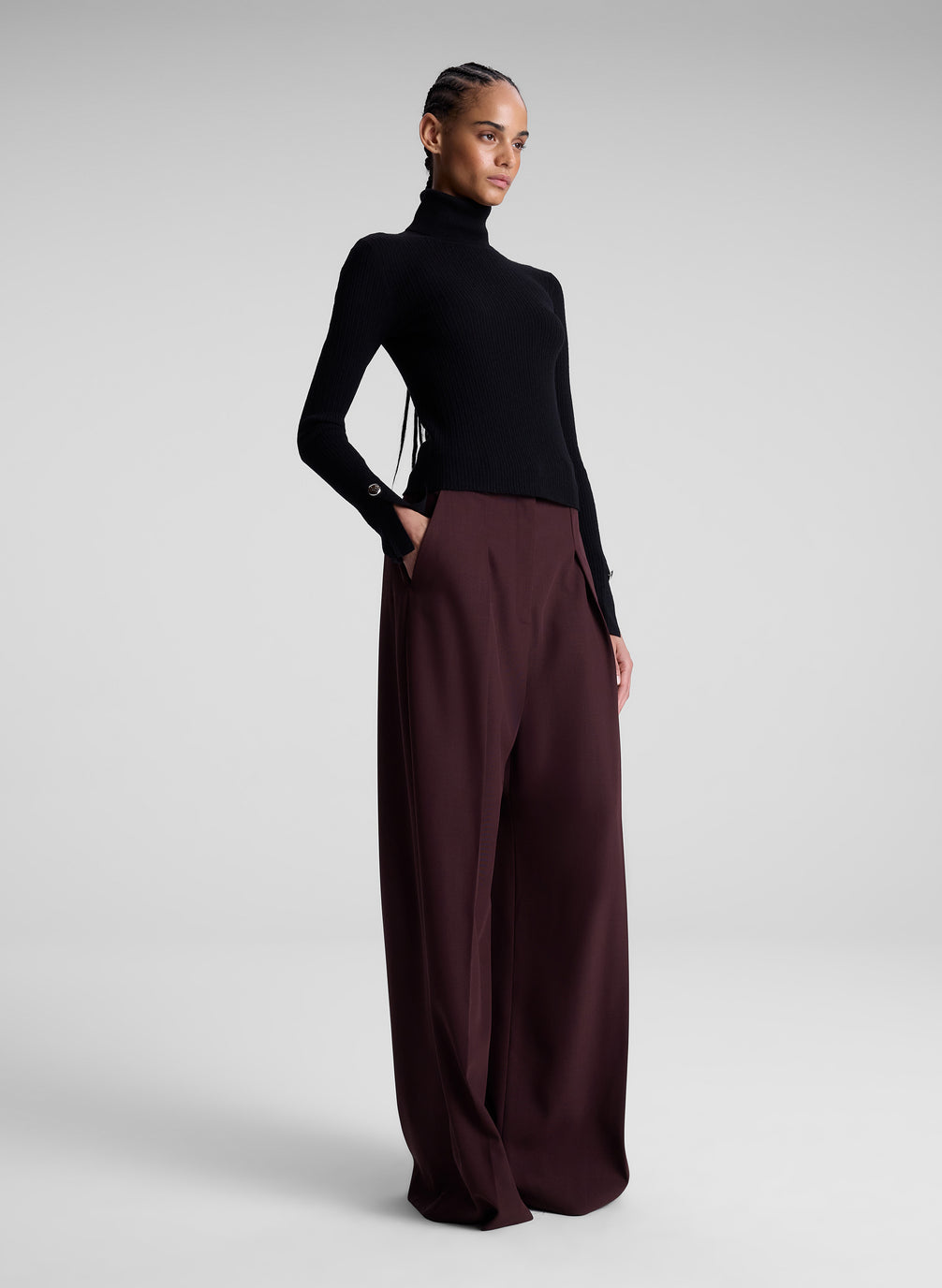 woman wearing black turtleneck and maroon pants