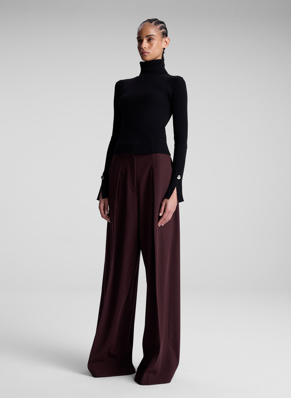 woman wearing black turtleneck and maroon pants