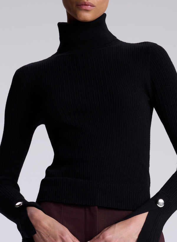 woman wearing black turtleneck and maroon pants