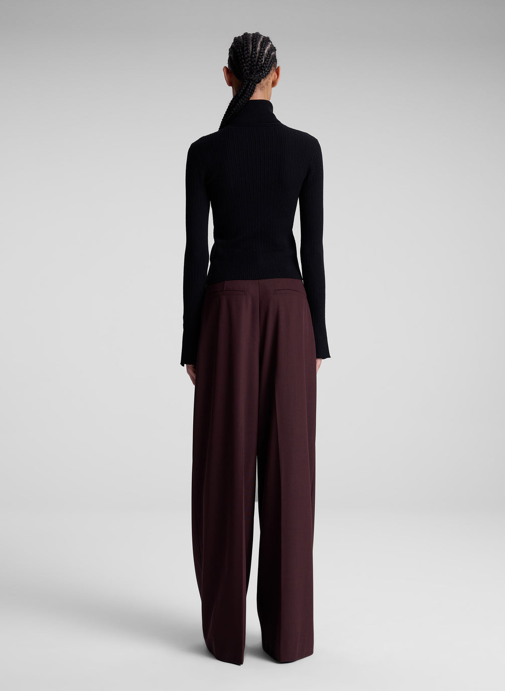 woman wearing black turtleneck and maroon pants