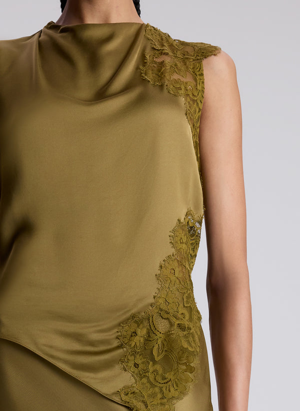 woman wearing olive lace and satin sleeveless top and matching skirt