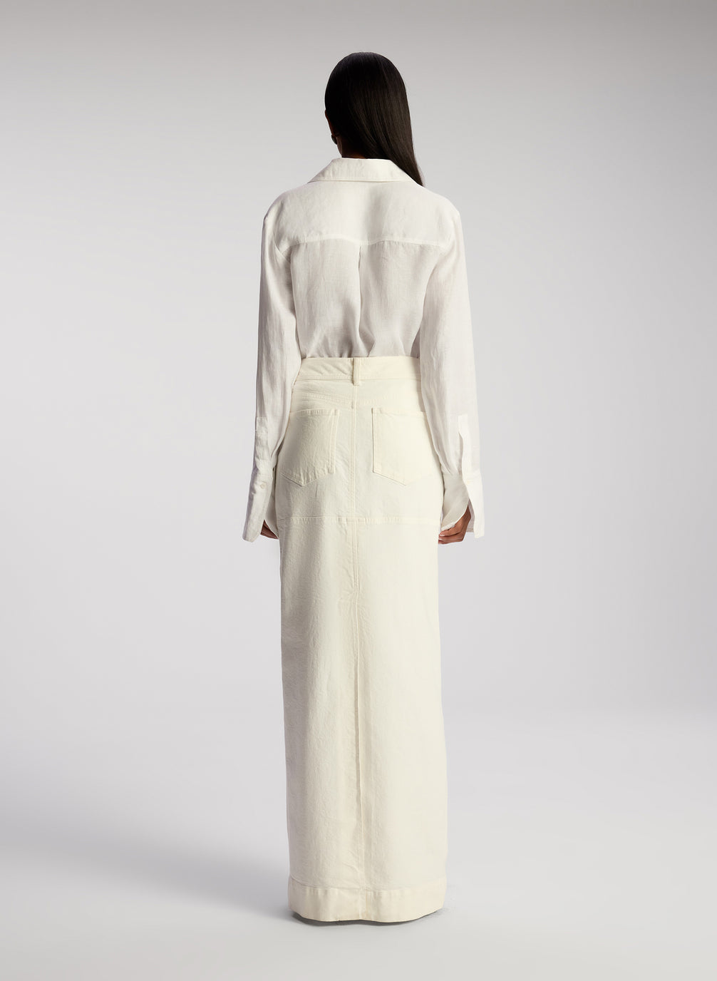 back view woman wearing white button down linen shirt and white maxi skirt