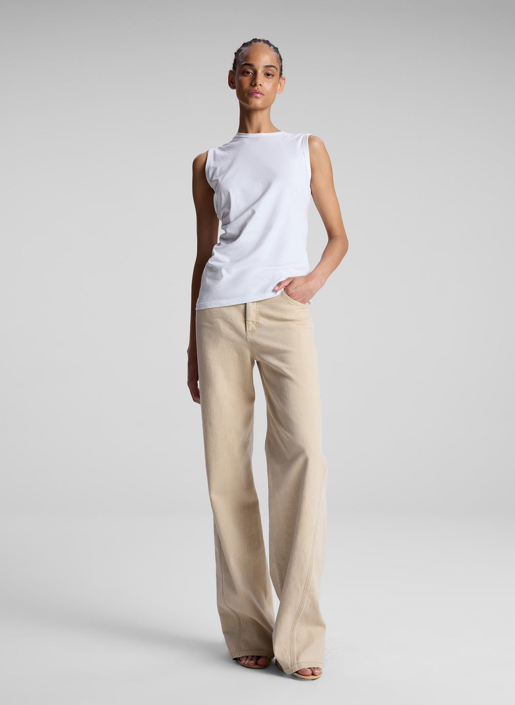 woman wearing white tank top and beige pants