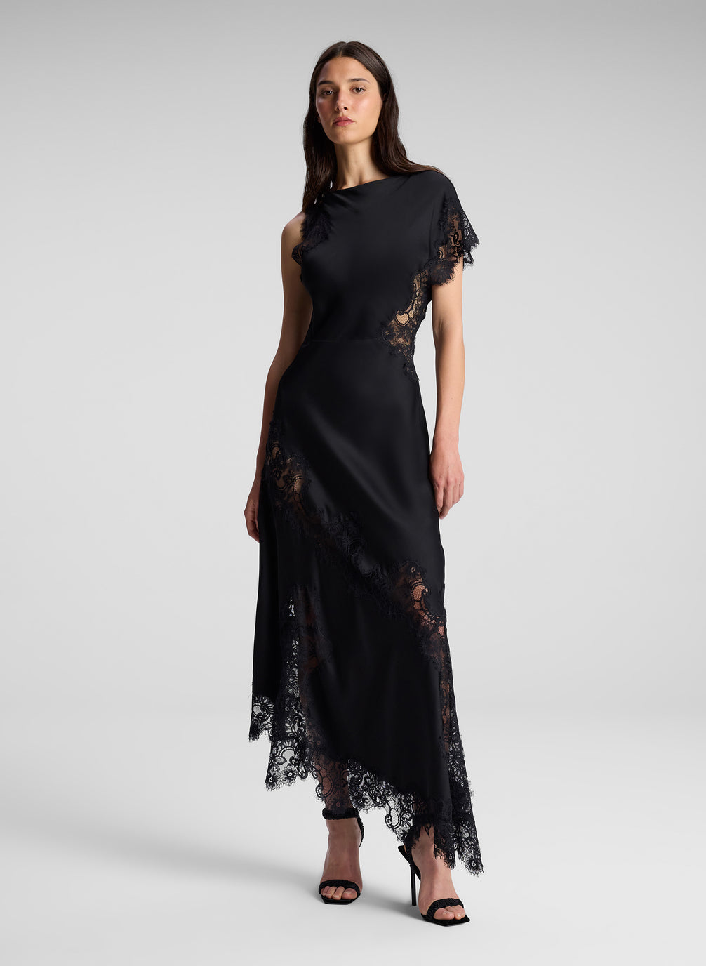 woman wearing black one shoulder lace dress