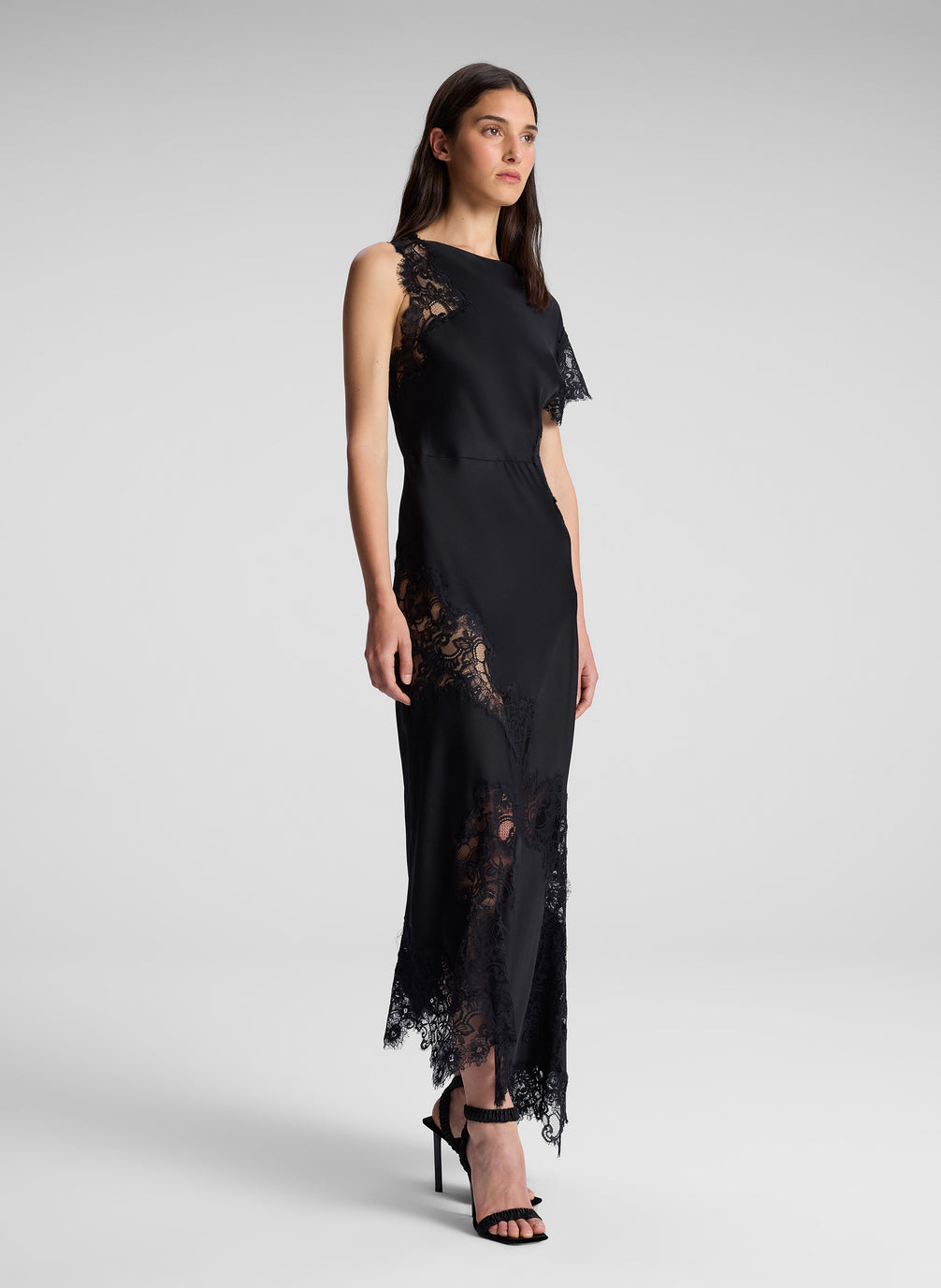 woman wearing black one shoulder lace dress