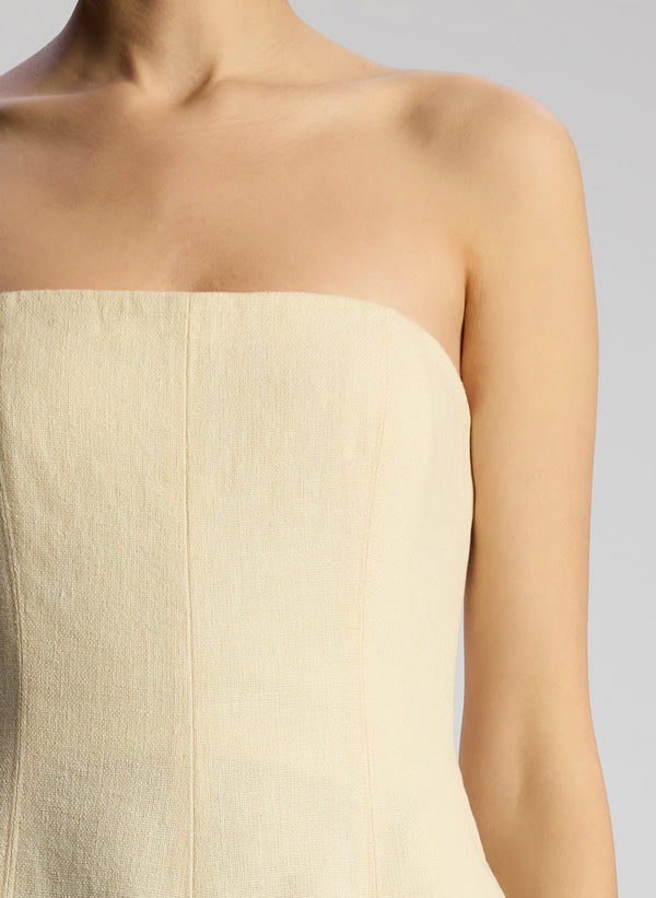 detail view of woman wearing cream strapless jumpsuit