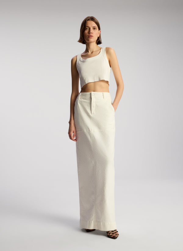 front view of woman wearing white cropped rib tank and white maxi skirt