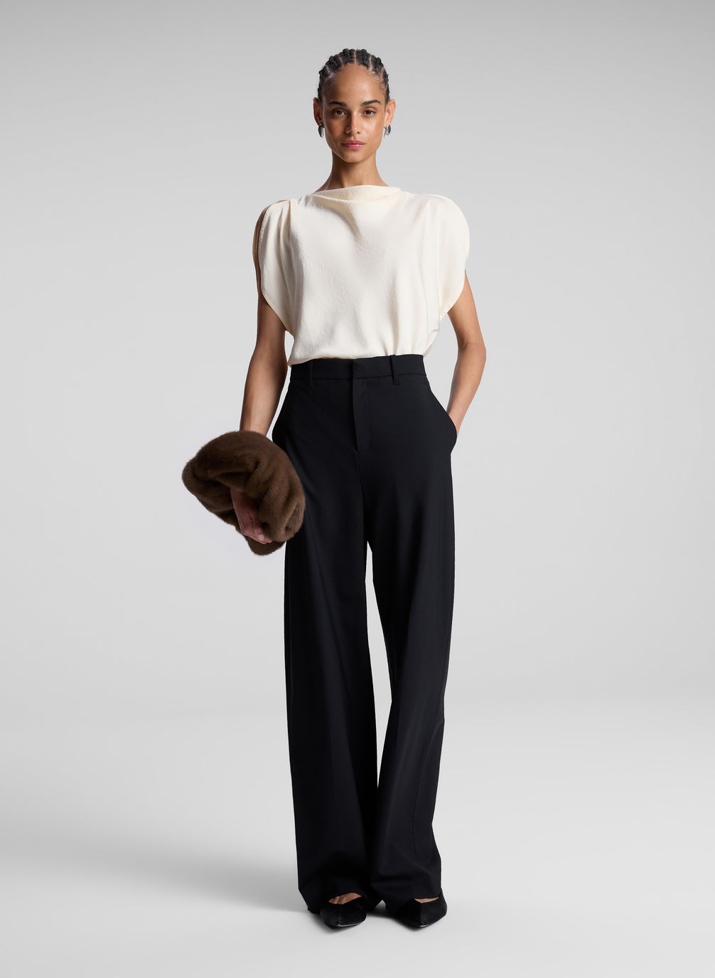 woman wearing off white blouse and black pants