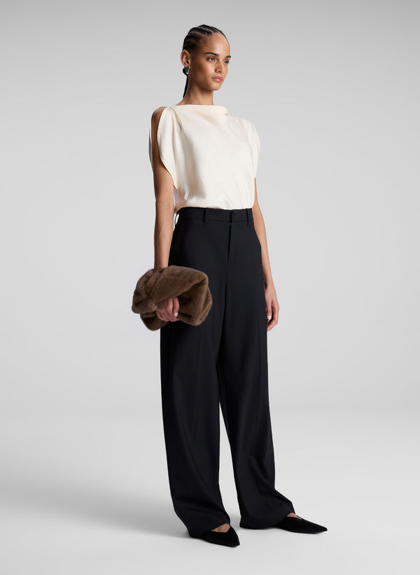 woman wearing off white blouse and black pants