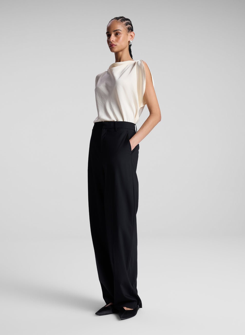 woman wearing off white blouse and black pants