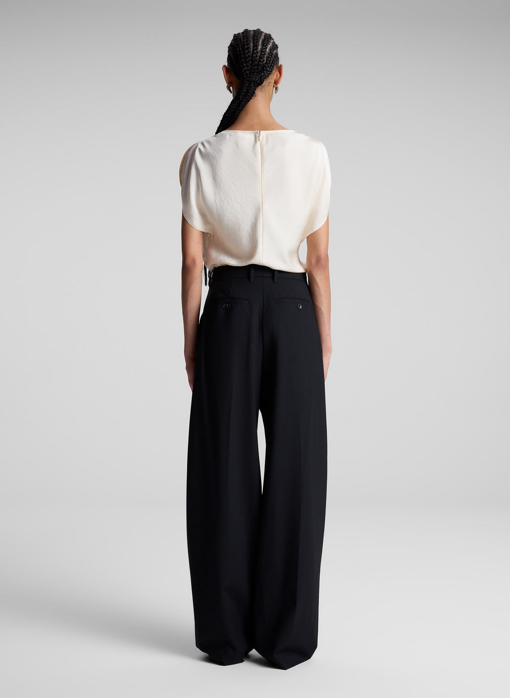 woman wearing off white blouse and black pants