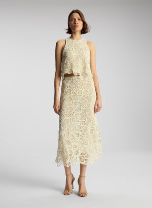front view of woman wearing off white lace shirt and skirt set