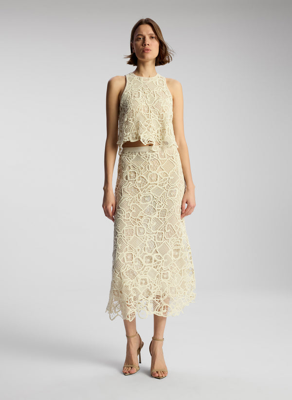 front view of woman wearing off white lace shirt and skirt set